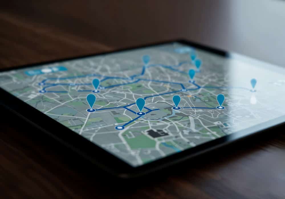 Tablet displaying a digital map with route markers and a connected delivery path.